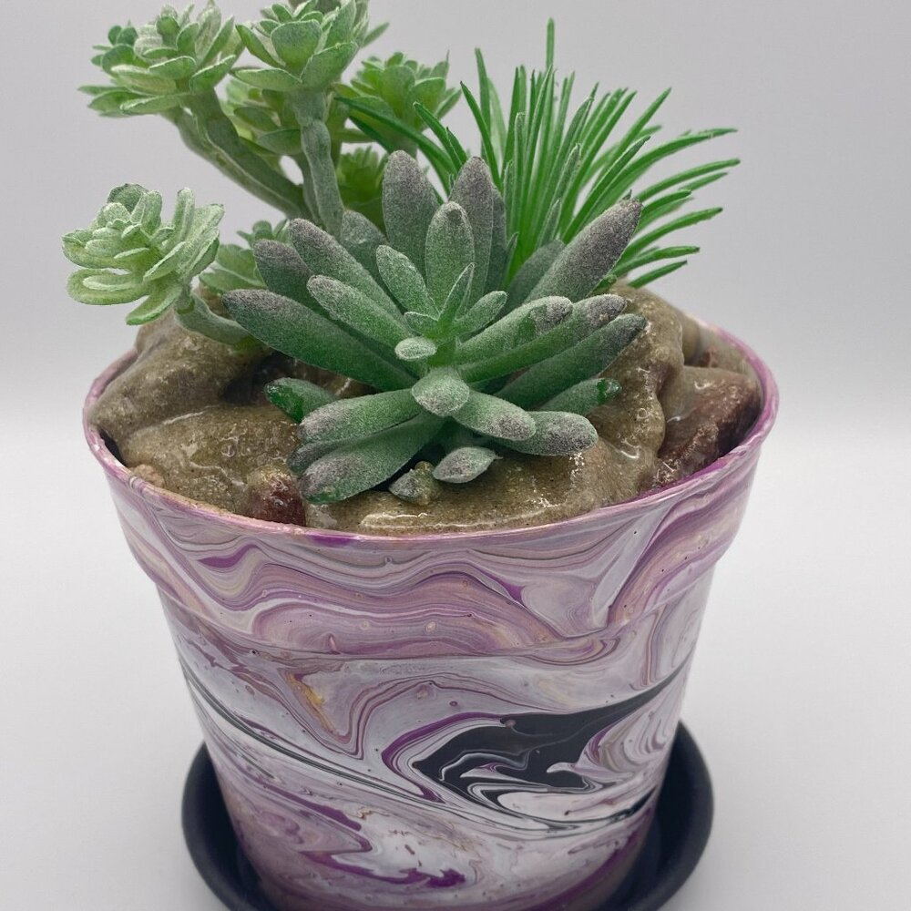 Acrylic paint pour pot with artificial succulents.